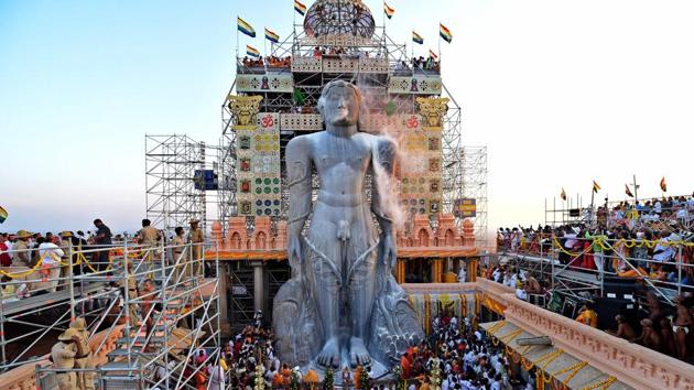 Devotees pour milk on the 57 ft-high monolythic statue of Lord Bahubali during the 88th "Mahamastakabhisheka", the 'grand head anointing ceremony' of the Jain deity atop Vindhyagiri mountain situated in Shravanabelgola town on February 17. (STR / AFP)