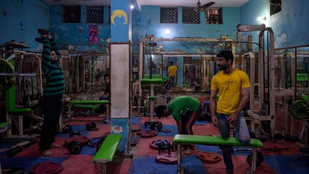 Men exercise in one of the oldest gyms in the old quarters of New Delhi on February 21. (Chandan Khanna / AFP)