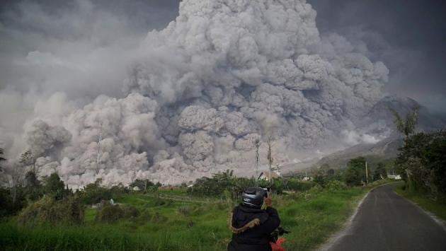 A man photographs Mount Sinabung volcano as it spews thick volcanic ash into the air in Karo, North Sumatra, on February 19. Sinabung roared back to life in 2010 for the first time in 400 years and has remained highly active since. (Endro Rusharya / AFP) A man photographs Mount Sinabung volcano as it spews thick volcanic ash into the air in Karo, North Sumatra, on February 19. Sinabung roared back to life in 2010 for the first time in 400 years and has remained highly active since. (Endro Rusharya / AFP)