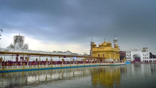 The Golden Temple in Amritsar looks surreal amid a backdrop of dark clouds on Saturday. (Sameer Sehgal/ht)