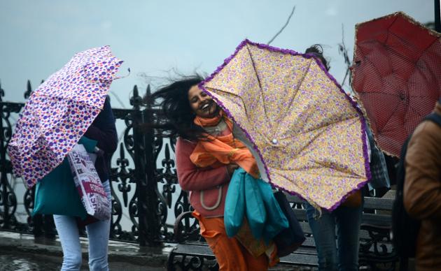 Tourists enjoying the weather change on The Ridge in Shimla on Saturday. (deepak sansta/ht)