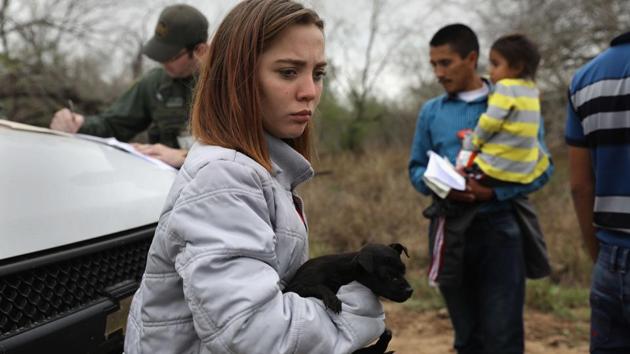 Central American immigrants turn themselves in to Border Patrol agents near McAllen, Texas. The girl, 14, from Honduras said that she had picked up the puppy in Reynosa, Mexico during her journey. Thousands of Central American families continue to enter the US, most seeking political asylum from violence in their home countries. The Rio Grande Valley has the highest number of undocumented immigrant crossings and narcotics smuggling of the entire US-Mexico border.(AFP)