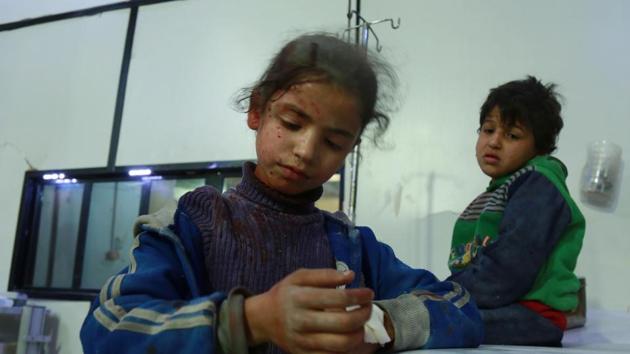 Two wounded Syrian children wait for medical aid at a makeshift hospital following air strikes by regime forces in the rebel-held town of Douma, in the besieged Eastern Ghouta region on the outskirts of the capital Damascus, on February 23. (AFP Photo) Two wounded Syrian children wait for medical aid at a makeshift hospital following air strikes by regime forces in the rebel-held town of Douma, in the besieged Eastern Ghouta region on the outskirts of the capital Damascus, on February 23. (AFP Photo)