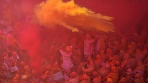 Devotees during celebration of Holi Festival at Sriji temple in Barsana, Uttar Pradesh on February 23. (AFP)