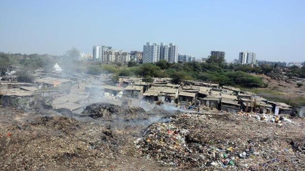 Schoolchildren walk past an illegal garbage dump yard at Wagholi. Residents say chronic garbage burning is leading to pollution of air and water.(Shankar Narayan/HT) Schoolchildren walk past an illegal garbage dump yard at Wagholi. Residents say chronic garbage burning is leading to pollution of air and water.(Shankar Narayan/HT)