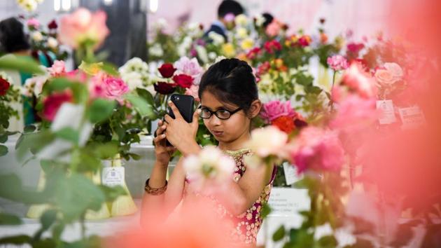 A little enthusiast takes pictures of the roses exhibited at the 101 Rose show by The Rose Society of Pune at Tilak Smarak Mandir. (Sanket Wankhade/HT PHOTO) A little enthusiast takes pictures of the roses exhibited at the 101 Rose show by The Rose Society of Pune at Tilak Smarak Mandir. (Sanket Wankhade/HT PHOTO)