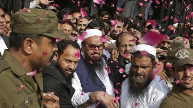 Supporters of Hafiz Saeed, center, head of the Pakistani religious party, Jamaat-ud-Dawa, is showered with rose petals by his supporters as he arrives to a court in Lahore, Pakistan. (AP File Photo) Supporters of Hafiz Saeed, center, head of the Pakistani religious party, Jamaat-ud-Dawa, is showered with rose petals by his supporters as he arrives to a court in Lahore, Pakistan. (AP File Photo)