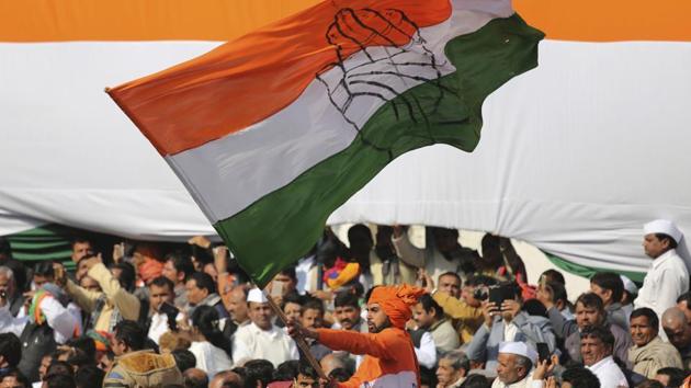 A Congress party worker waves the party flag during a function to celebrate Rahul Gandhi taking over as party's president from her mother Sonia Gandhi in New Delhi. (AP File Photo) A Congress party worker waves the party flag during a function to celebrate Rahul Gandhi taking over as party's president from her mother Sonia Gandhi in New Delhi. (AP File Photo)