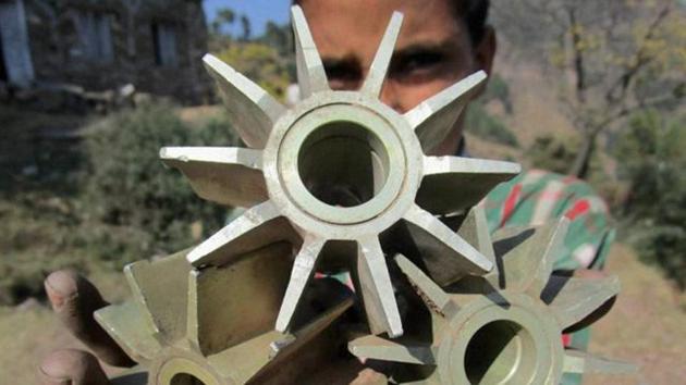 A villager showing remains of mortar shells fired from across the LoC by Pakistan at Mankot in Poonch district in Jammu. (PTI File Photo)