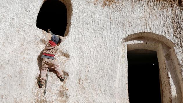 Ahlem, four, climbs up a wall to reach her rabbit’s hideaway at her house. Many families left these houses when new towns and villages were built in the 1960s and 1970s as part of a modernisation drive by President Habib Bourguiba. Locals suspect Bourguiba wanted to dilute Berber communities as he strove to integrate them into the Arab nation after independence from France. (Zohra Bensemra / REUTERS) Ahlem, four, climbs up a wall to reach her rabbit’s hideaway at her house. Many families left these houses when new towns and villages were built in the 1960s and 1970s as part of a modernisation drive by President Habib Bourguiba. Locals suspect Bourguiba wanted to dilute Berber communities as he strove to integrate them into the Arab nation after independence from France. (Zohra Bensemra / REUTERS)