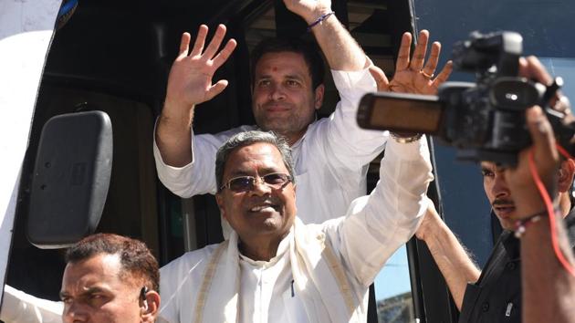 Congress president Rahul Gandhi and Karnataka chief minister Siddaramaiah wave from a bus after visiting Shree Renuka Yellamma Temple in Belgaum on Monday. (Arijit Sen/HT Photo) Congress president Rahul Gandhi and Karnataka chief minister Siddaramaiah wave from a bus after visiting Shree Renuka Yellamma Temple in Belgaum on Monday. (Arijit Sen/HT Photo)
