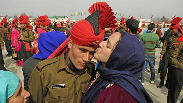 A relative kisses a new recruit after the graduation ceremony of the Jammu Kashmir Light Infantry Regiment (JKLIR) at an army base on the outskirts of Srinagar. (Waseem Andrabi / HT Photo) A relative kisses a new recruit after the graduation ceremony of the Jammu Kashmir Light Infantry Regiment (JKLIR) at an army base on the outskirts of Srinagar. (Waseem Andrabi / HT Photo)