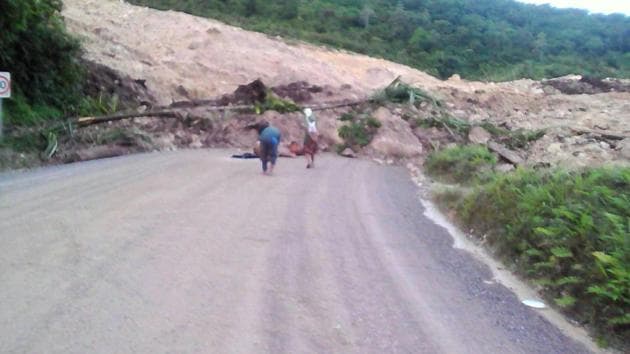 A supplied image shows locals inspecting a landslide and damage to a road located near the township of Tabubil after an earthquake that struck Papua New Guinea's Southern Highlands, February 26, 2018. (REUTERS) A supplied image shows locals inspecting a landslide and damage to a road located near the township of Tabubil after an earthquake that struck Papua New Guinea's Southern Highlands, February 26, 2018. (REUTERS)