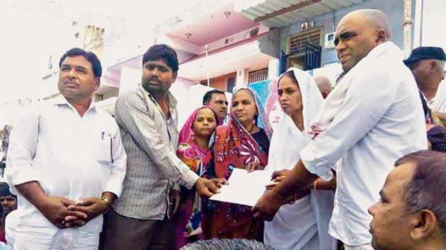 Hemaben Vankar received the land title for an eight hectare patch of land in Dudhka village on February 20, after activist Bhanubhai Vankar set himself on fire in protest against delays.(HT Photo)