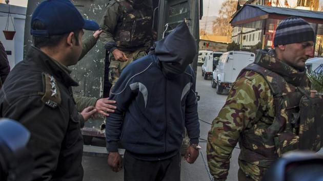 A militant being escorted by police to be present before the media at Police Control Room in Srinagar. (HT File Photo) A militant being escorted by police to be present before the media at Police Control Room in Srinagar. (HT File Photo)