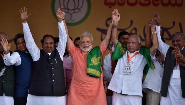 The Prime Minister of India Narendra Modi with Karnataka state President and BJP chief ministerial candidate for upcoming state Assembly election BS Yeddyurappa and K S Eshwarappa during Farmer's Convention in Davangere, India, on Tuesday, February 27, 2018.(Arijit Sen/HT Photo)