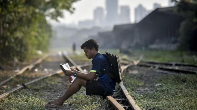 Mumbai has seen some of its most iconic landmarks shut over the last few years. Rhythm House, Samovar and now Strand Book Stall have been the most noted of them all. However, the city’s love for reading is unquestionable, as clearly demonstrated by a young reader engrossed in a magazine by an unused set of railway tracks at Reay Road station. (Kunal Patil / HT Photo) Mumbai has seen some of its most iconic landmarks shut over the last few years. Rhythm House, Samovar and now Strand Book Stall have been the most noted of them all. However, the city’s love for reading is unquestionable, as clearly demonstrated by a young reader engrossed in a magazine by an unused set of railway tracks at Reay Road station. (Kunal Patil / HT Photo)