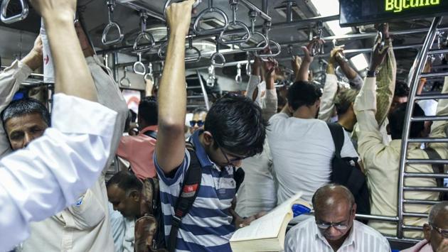 For the busy commuter, the best use of time on a local train is still reading a book.  (Kunal Patil / HT Photo) 
