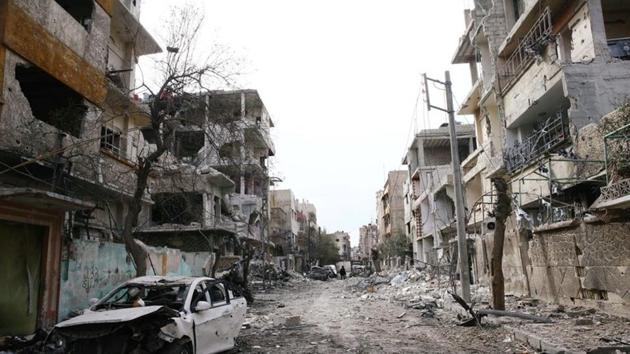 Damaged cars and buildings are seen in the besieged town of Douma, Eastern Ghouta. (Reuters Photo) Damaged cars and buildings are seen in the besieged town of Douma, Eastern Ghouta. (Reuters Photo)