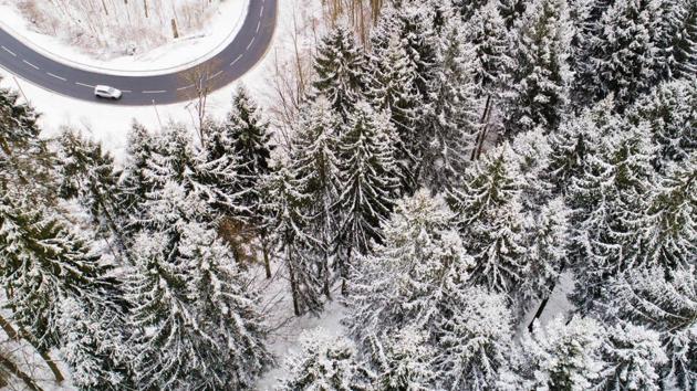 A car drives down a country road through a snowy forest in Holzminden, Germany. A blast of Siberian weather dubbed “The Beast from the East” sent temperatures plunging across much of Europe early Tuesday as commuters braced themselves for another day of travel chaos. (Julian Stratenschulte / dpa / AFP) A car drives down a country road through a snowy forest in Holzminden, Germany. A blast of Siberian weather dubbed “The Beast from the East” sent temperatures plunging across much of Europe early Tuesday as commuters braced themselves for another day of travel chaos. (Julian Stratenschulte / dpa / AFP)