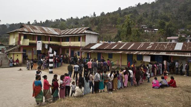People stand in queue to cast votes outside a polling station during the Meghalaya state assembly election in Nongpoh. Elections are underway for 59 seats each in Meghalaya and Nagaland. The counting of votes is scheduled for March 3, along with Tripura, which went to the polls on February 18. One person was reported injured in a grenade blast in a polling booth in Nagaland. (Anupam Nath / AP)