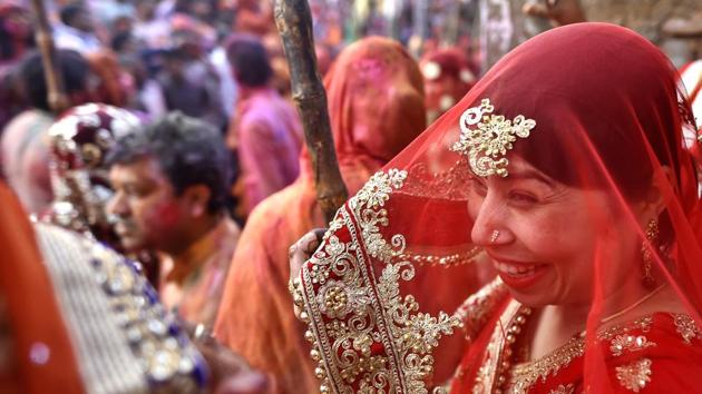 The festival is considered a recreation of when Krishna entered Barsana to tease Radha and was met with her friends and the women of the village who chased him out with sticks. The next year, other men from Nandgaon followed in Krishna’s steps to similar fates and over time the event is believed to have evolved into the Lathmar Holi played today. (Ajay Aggarwal / HT Photo) 