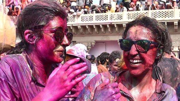 The sight of men cowering under shields as women decked in red rain blows while singing songs in Braj has become a major attraction in itself and draws huge crowds of not just participants but also spectators from the all parts of the country and beyond.  (Ajay Aggarwal / HT Photo) 