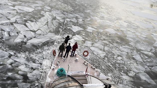 Passengers stand on the deck of a tourist boat as it breaks through the frozen Moskva River in Moscow, Russia. Freezing temperatures have claimed at least 10 lives across the continent in the last three days with particularly acute fears for rough sleepers and the elderly during the bitterly cold snap. (Alexander Zemlianichenko / AP) Passengers stand on the deck of a tourist boat as it breaks through the frozen Moskva River in Moscow, Russia. Freezing temperatures have claimed at least 10 lives across the continent in the last three days with particularly acute fears for rough sleepers and the elderly during the bitterly cold snap. (Alexander Zemlianichenko / AP)