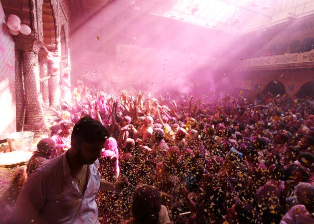 Devotees smear each other with coloured powder during Holi celebrations at Banke Bihari temple in Vrindavan on Tuesday. (Sonu Mehta / HT Photo)