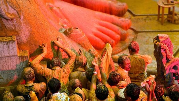 Devotees standing at the feet of the colossal rock-cut statue were seen soaked in the colours of sandalwood and turmeric that was poured on the towering statue. The festivities, which began on February 7 with a series of Panchakalyana rituals, leading to Mahamastakabhisheka on February 17, will go on till February 26. (PTI) Devotees standing at the feet of the colossal rock-cut statue were seen soaked in the colours of sandalwood and turmeric that was poured on the towering statue. The festivities, which began on February 7 with a series of Panchakalyana rituals, leading to Mahamastakabhisheka on February 17, will go on till February 26. (PTI)