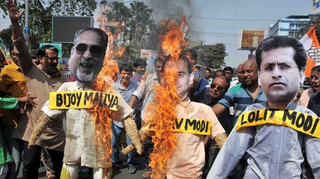 Congress activists burn Nirav Modi,Vijay Mallya and Lalit Modi in effigy during a protest, Kolkata, February 18(PTI)