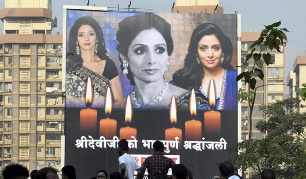 Fans gather near a hoarding of veteran actor Sridevi to pay homage.(PTI)