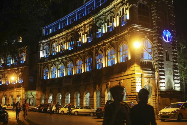 A State Bank of India Ltd. (SBI) building stands illuminated at night in Mumbai, India.(Dhiraj Singh/Bloomberg)