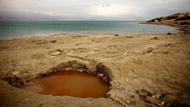 But in recent years, beaches have shut down as signs warning against sinkholes have sprung up along the shoreline. The sinkholes are a result of mineral mining and the interaction between freshwater and a salt layer, buried deep beneath the surface. As fresh water dissolves the salt, it creates an underground void, leading to sudden collapses on the surface. (Ronen Zvulun / REUTERS) But in recent years, beaches have shut down as signs warning against sinkholes have sprung up along the shoreline. The sinkholes are a result of mineral mining and the interaction between freshwater and a salt layer, buried deep beneath the surface. As fresh water dissolves the salt, it creates an underground void, leading to sudden collapses on the surface. (Ronen Zvulun / REUTERS)