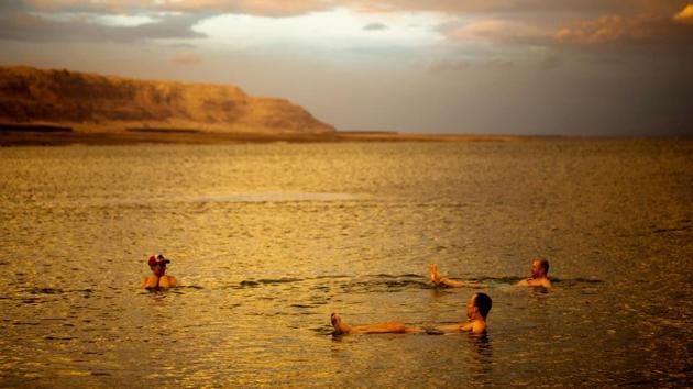 Tourists from Poland float in the Dead Sea during sunset near Metzoke Dragot. During high season in winter when the heat is bearable, tourists flock here for getaways. Sufferers from chronic skin diseases, such as psoriasis and eczema, routinely make pilgrimages drawn by claims of the Sea’s miraculous healing properties. (Ronen Zvulun / REUTERS) Tourists from Poland float in the Dead Sea during sunset near Metzoke Dragot. During high season in winter when the heat is bearable, tourists flock here for getaways. Sufferers from chronic skin diseases, such as psoriasis and eczema, routinely make pilgrimages drawn by claims of the Sea’s miraculous healing properties. (Ronen Zvulun / REUTERS)