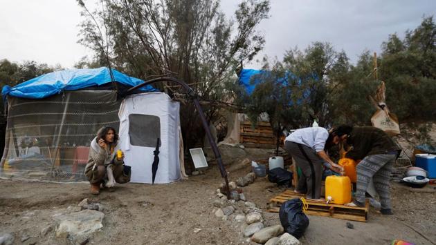 Avraham (L) sits near his makeshift camp as Bar (R) and his friend pour water into a container, on the shore of the Dead Sea. Today, a handful of Zulas, Hebrew slang for a hangout, dot the beach. They are mostly built with branches, tarp and old sheets that provide the beach’s hermits cover from the baking sun. (Ronen Zvulun / REUTERS) Avraham (L) sits near his makeshift camp as Bar (R) and his friend pour water into a container, on the shore of the Dead Sea. Today, a handful of Zulas, Hebrew slang for a hangout, dot the beach. They are mostly built with branches, tarp and old sheets that provide the beach’s hermits cover from the baking sun. (Ronen Zvulun / REUTERS)