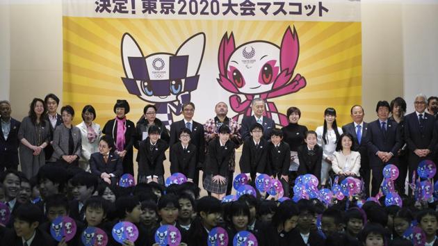Officials and students pose for photographers after the Tokyo 2020 Olympic Games mascot was unveiled. (AP) Officials and students pose for photographers after the Tokyo 2020 Olympic Games mascot was unveiled. (AP)