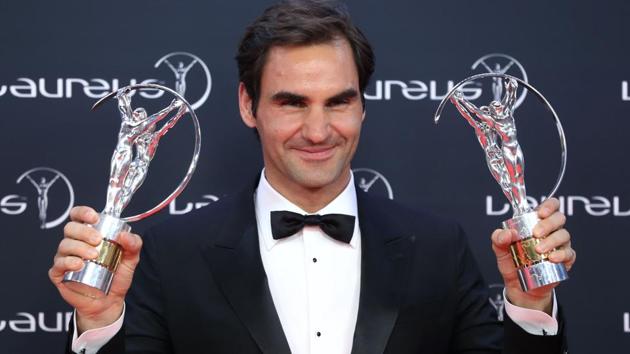 Roger Federer poses with his two trophies at the Laureus Awards. (AFP)