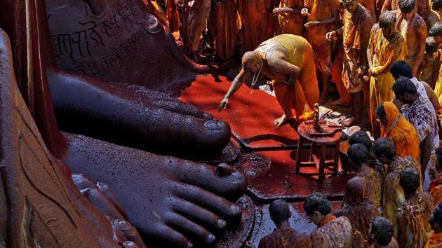 A devotee touches the feet of the monolithic statue of Jain deity Gomateshwara Bahubali as he celebrates the Mahamastakabhisheka, or the head-anointing ceremony of the statue, in Shravanabelagola. The ceremony unfolded on Saturday at this pilgrimage centre amidst a montage of traditional rituals. A devotee touches the feet of the monolithic statue of Jain deity Gomateshwara Bahubali as he celebrates the Mahamastakabhisheka, or the head-anointing ceremony of the statue, in Shravanabelagola. The ceremony unfolded on Saturday at this pilgrimage centre amidst a montage of traditional rituals.