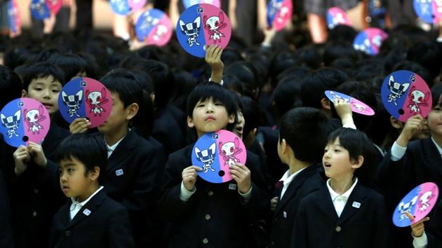 School students hold paper fans featuring the mascot for the Tokyo 2020 Olympics and Paralympics. (REUTERS) School students hold paper fans featuring the mascot for the Tokyo 2020 Olympics and Paralympics. (REUTERS)