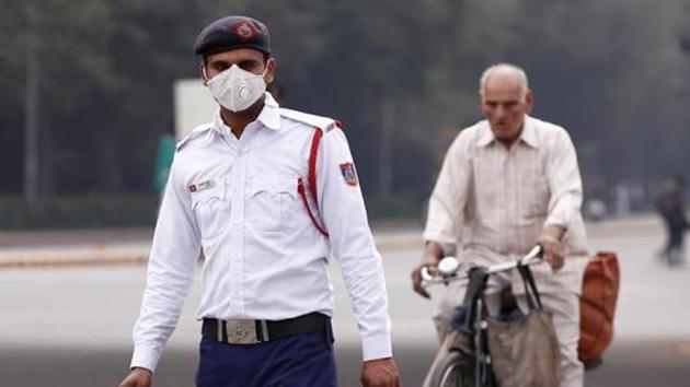 A traffic policeman wearing a mask to protect himself from dust and air pollution stands on a road in New Delhi on February 6. (Reuters File Photo) A traffic policeman wearing a mask to protect himself from dust and air pollution stands on a road in New Delhi on February 6. (Reuters File Photo)