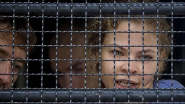 Anastasia Vashukevich talks from inside a police transport vehicle at a detention center in Pattaya, south of Bangkok. (AP) Anastasia Vashukevich talks from inside a police transport vehicle at a detention center in Pattaya, south of Bangkok. (AP)