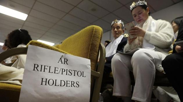 A sign directs people with guns during the ceremony. The event fell on the same day students returned to their high school in Florida for the first time since a 19-year-old used an AR-15 to kill 17 students and school staff two weeks ago. With the United States again riled by debate on gun control, an elementary school near the Sanctuary closed for the day. (Spencer Platt / Getty Images / AFP)