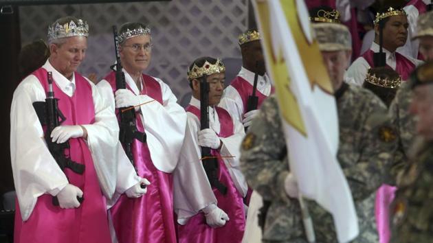 The commitment ceremony, attended by around 500 people, evoked some of the mass weddings, for which Hyung Jin Moon’s father was famous, with the younger Moon deviating in encouraging congregants to carry an AR-15. (Jacqueline Larma / AP)