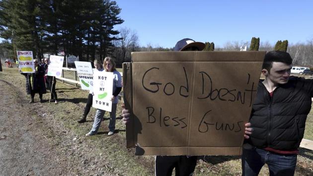 A dozen protesters gathered outside the event, holding up posters that read “Worship God, Not Guns” and “God Does Not Bless Guns.” Demonstrators described the event tantamount to political endorsement and that it was “time to revoke” the non-profit status of such religious groups. (Jacqueline Larma / AP)