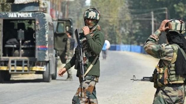 Paramilitary troopers stand guard after a gunfight with militants at Hajin village in Kashmir's Bandipora district, in October 2017.