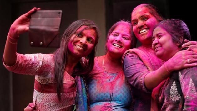 Teachers take a selfie during Holi celebrations, inside a school in Ahmedabad, on Thursday. (Reuters) Teachers take a selfie during Holi celebrations, inside a school in Ahmedabad, on Thursday. (Reuters)