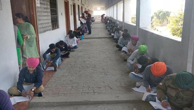 Students sitting on mats during their Class-12 PSEB exam at Government senior Secondary School, Talwandi Rai, Raiko on Wednesday. (Gurminder Singh/HT) Students sitting on mats during their Class-12 PSEB exam at Government senior Secondary School, Talwandi Rai, Raiko on Wednesday. (Gurminder Singh/HT)
