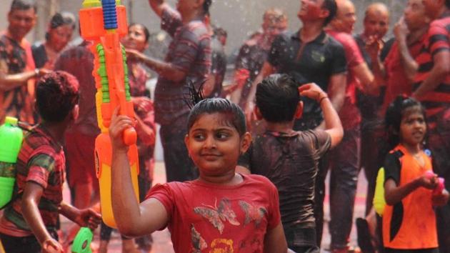 Many of the water guns, or pichkaris, have small water containers strapped to the back.