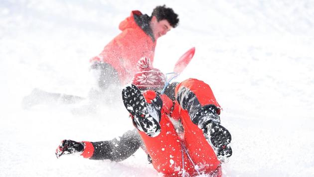 There was joy for tens of thousands of children who had an unexpected day off school and took to the slopes on sledges. (Andy Buchanan / AFP)
